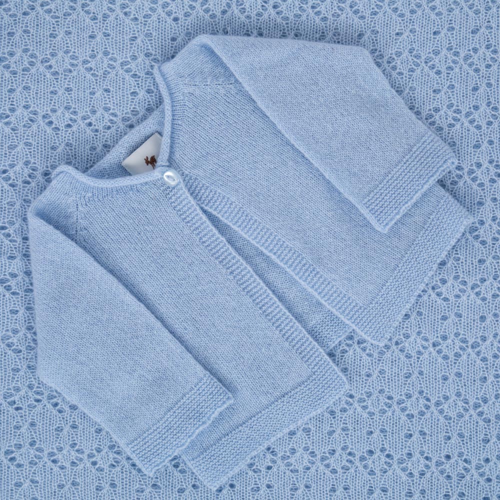 Blue cashmere baby cardigan on shawl